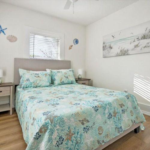 Upstairs guest bedroom 2 with full bed and two night stands and closet.