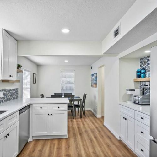 Fully remodeled kitchen with full Stainless Steel appliance set includes, refrigerator with ice maker and water dispenser, oven with range, dishwasher, and microwave.