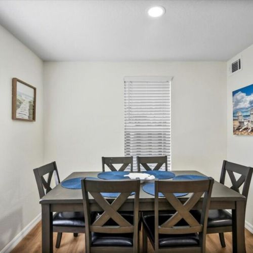 Dining room with seating for 6 at the table and 2 seats at the kitchen bar.